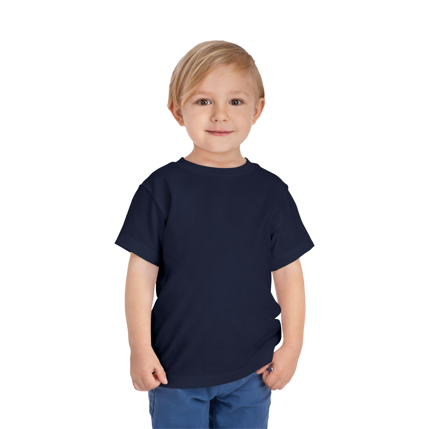 A young boy with blonde hair is smiling and standing against a black background.