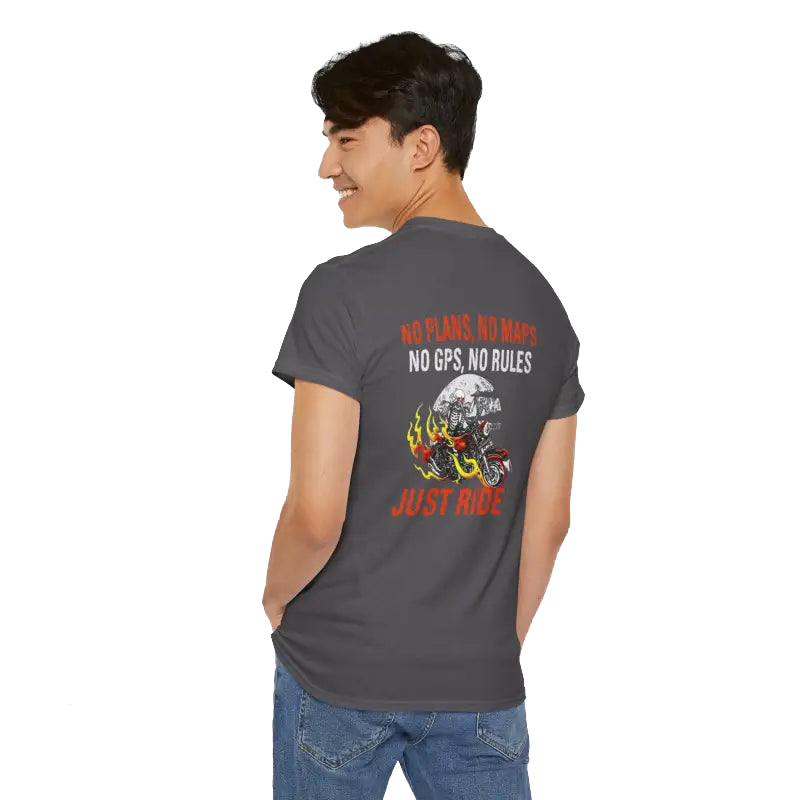 A young man wearing a grey t-shirt with a graphic design and text on the back.