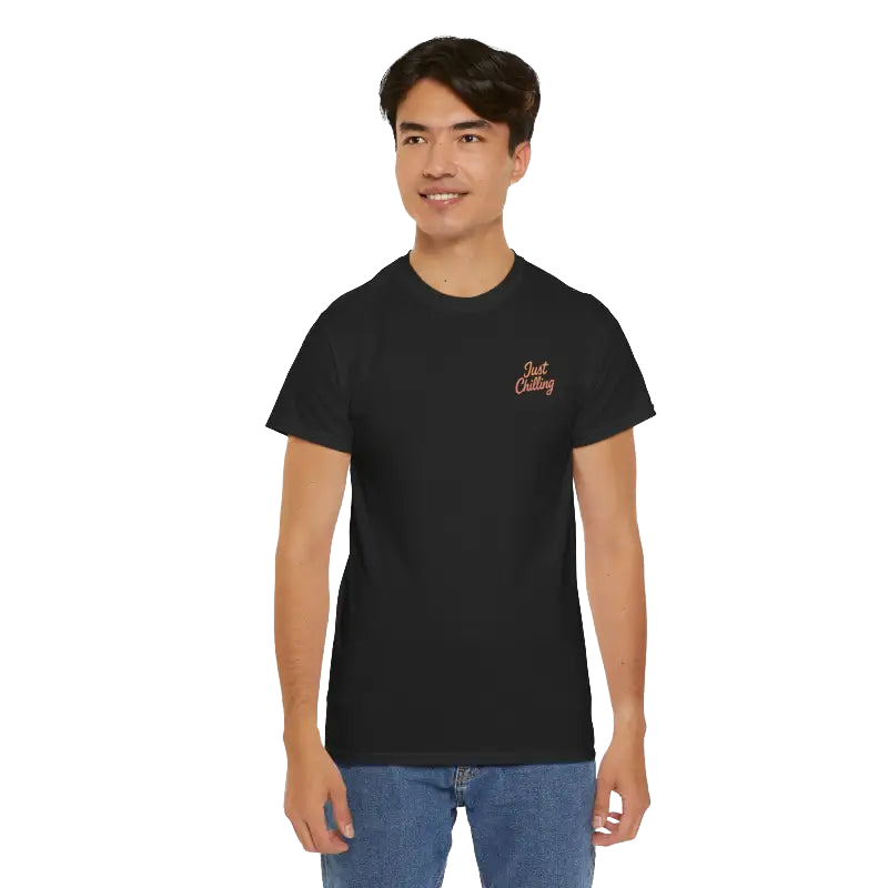 A young man wearing a black t-shirt with a logo on it, smiling at the camera.
