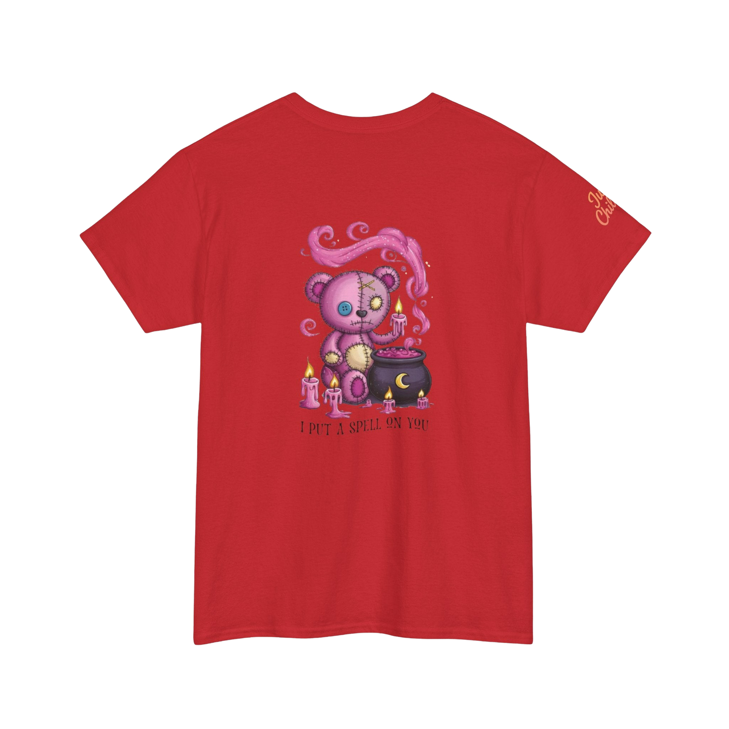 A red t-shirt with a graphic design depicting a pink teddy bear surrounded by candles and a cauldron, with the text "I PUT SPELLING ON YOU" below the image.