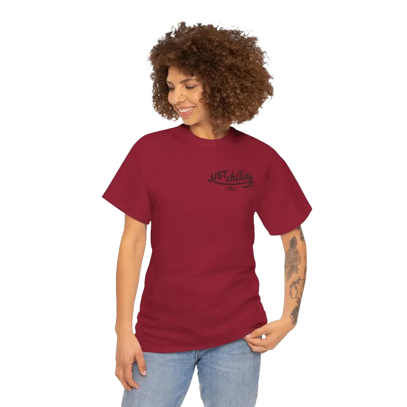 A smiling woman with curly hair wearing a red t-shirt with the text "JUST KILLING INC." printed on it.