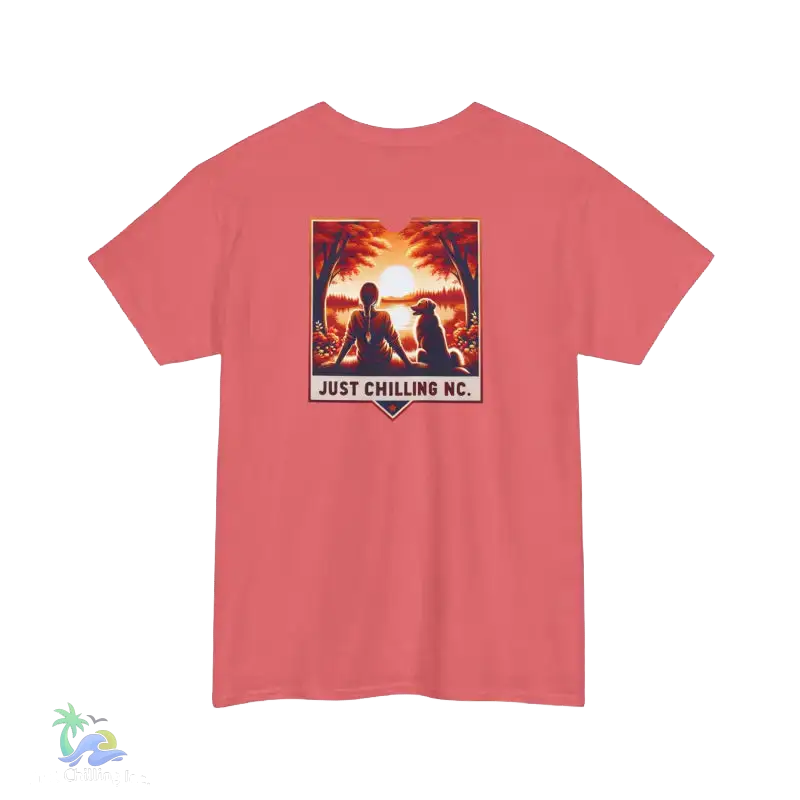 A red t-shirt with a graphic design depicting two people sitting in a tropical setting, with a sunset in the background. The text below the graphic says "JUST CHILLING NC".