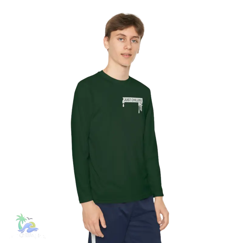 a young man wearing a green long sleeve shirt