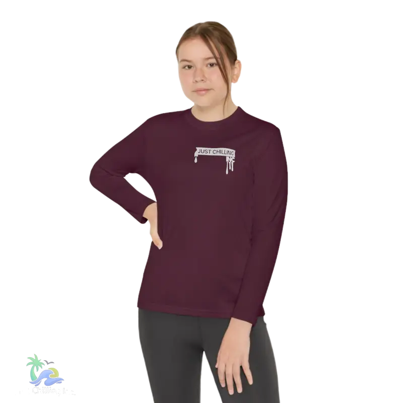 a woman wearing a maroon shirt with a white logo on it