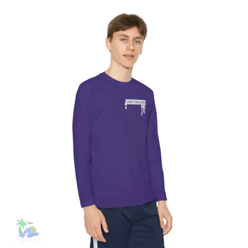 a young man wearing a purple shirt and blue shorts