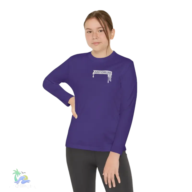 a woman wearing a purple shirt with a white stick on it