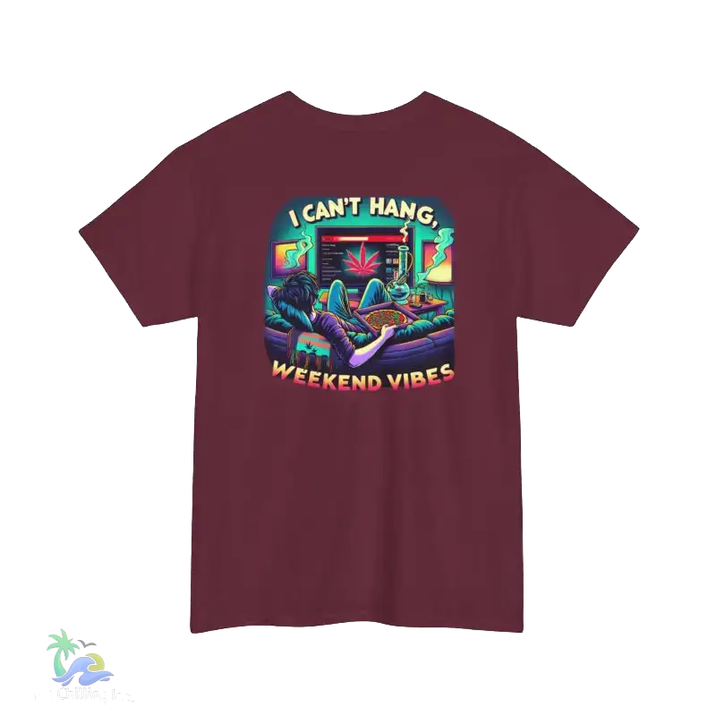A maroon t-shirt with a colorful graphic design depicting a person lounging in a chair with a computer monitor, surrounded by various objects and text that reads "I CAN'T HANG. WEEKEND VIBES".