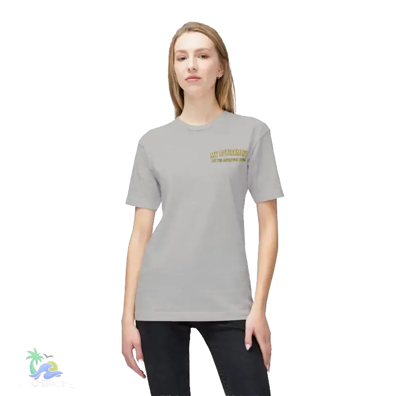 A woman wearing a grey t-shirt with a yellow text logo on the left side of her chest.