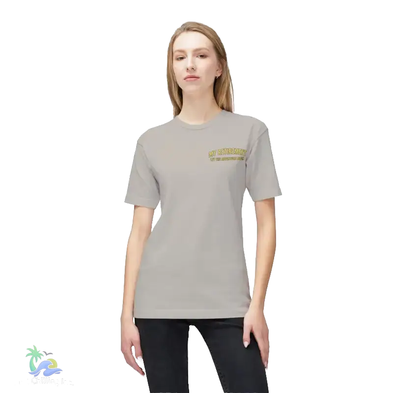 A woman wearing a grey t-shirt with a yellow text logo on the left side of her chest.