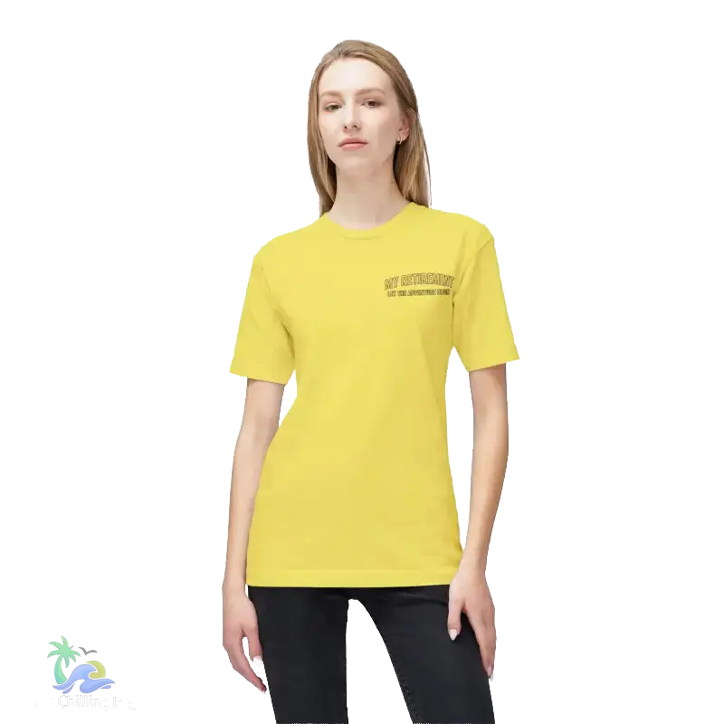 A woman wearing a yellow t-shirt with text on it, standing against a black background.