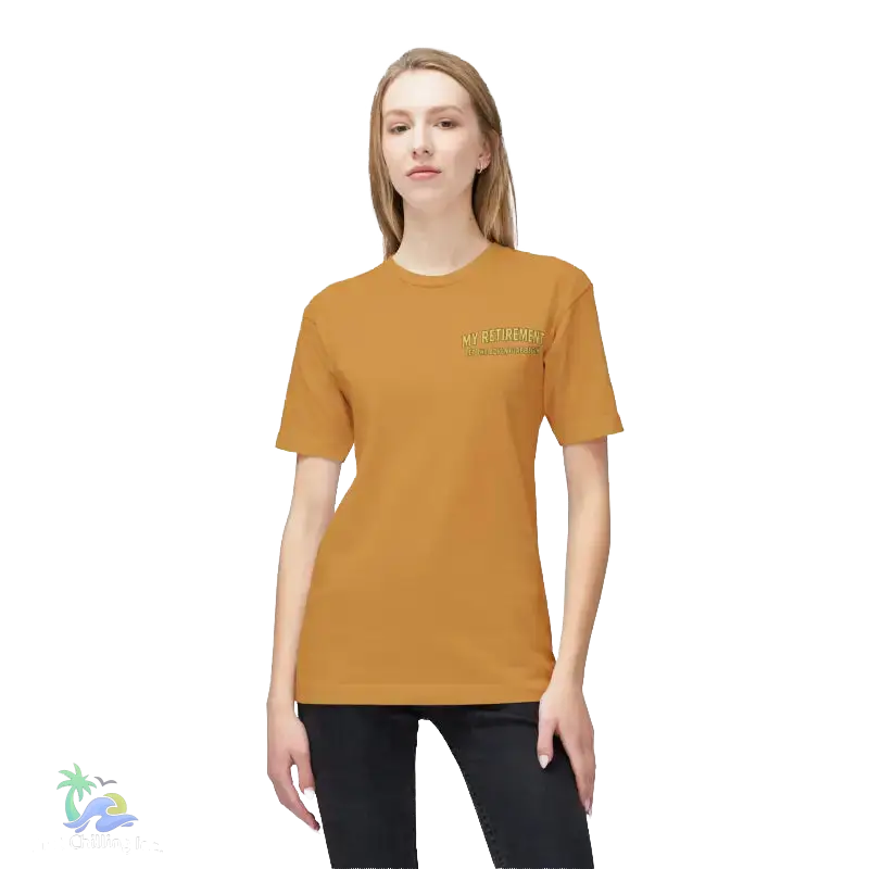 A woman wearing a yellow t-shirt with a logo stands against a black background.