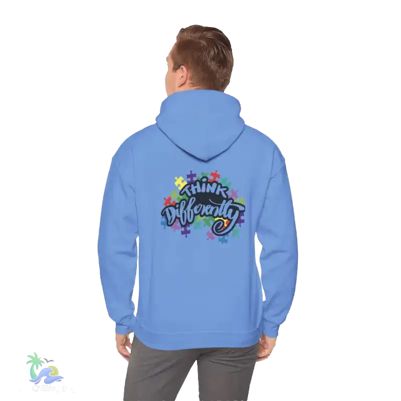 A person wearing a blue hoodie with a colorful graphic and text on the back.
