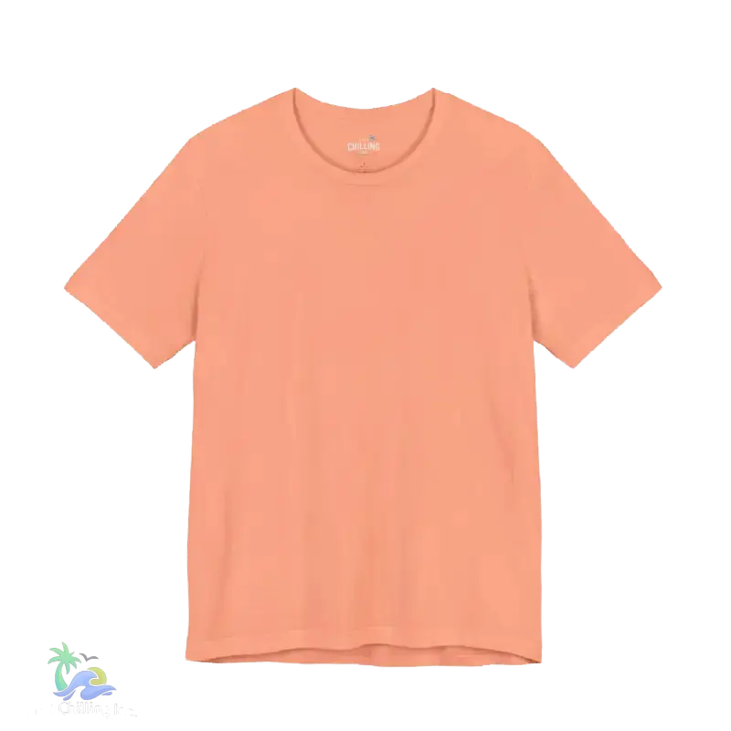 A simple peach-colored t-shirt is shown against a black background.