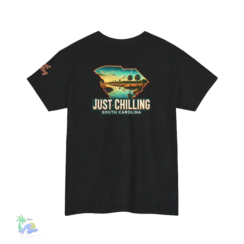 A black t-shirt with a graphic design depicting a scenic landscape with a body of water and palm trees. The text on the t-shirt reads "Just Chilling South Carolina".