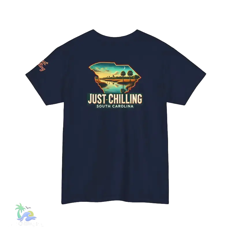 A navy blue t-shirt with a graphic design depicting a scenic landscape with palm trees and a body of water, along with the text "Just Chilling South Carolina".