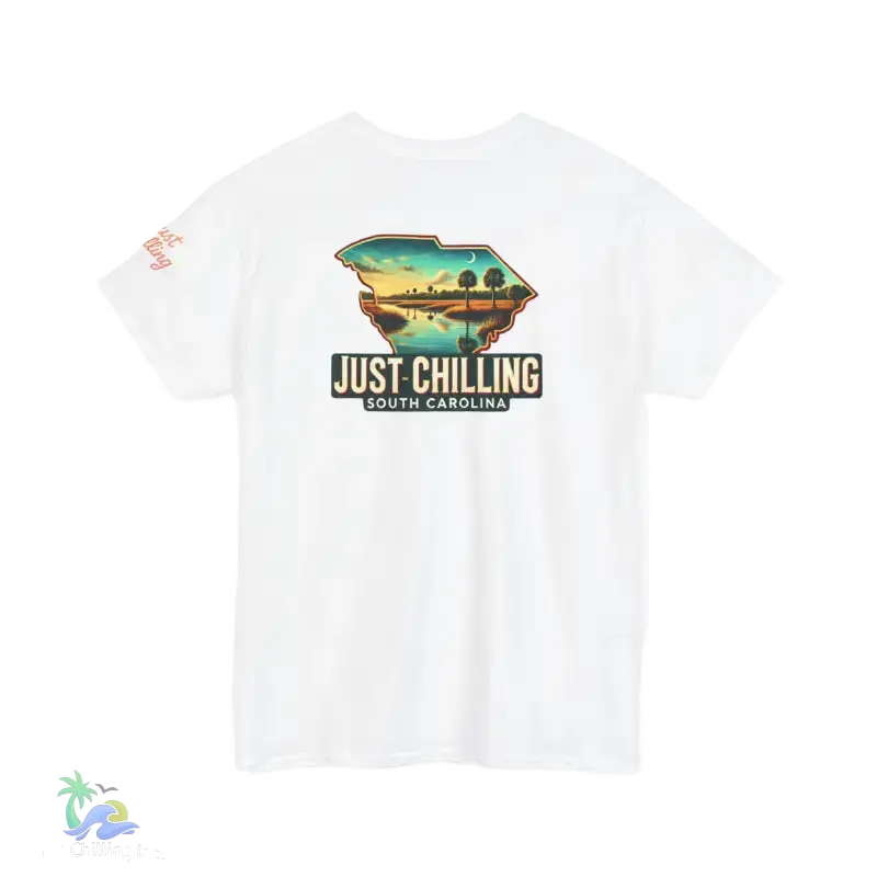 A white t-shirt with a graphic design depicting a scenic landscape with a body of water and palm trees. The text on the t-shirt reads "Just Chilling South Carolina".