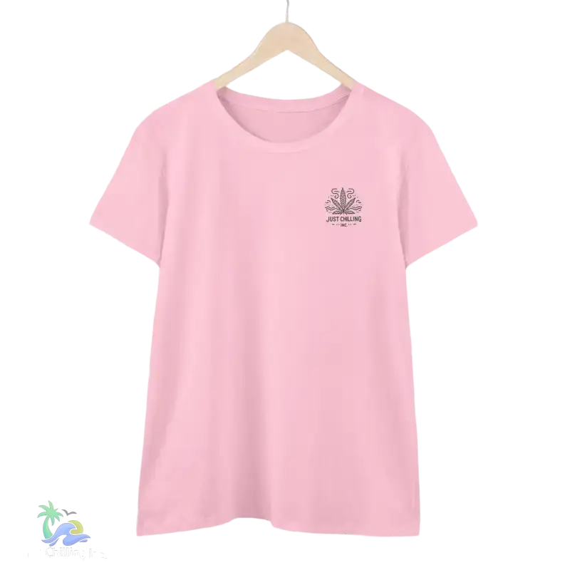 A pink t-shirt with a graphic design on the front, hanging on a wooden hanger.