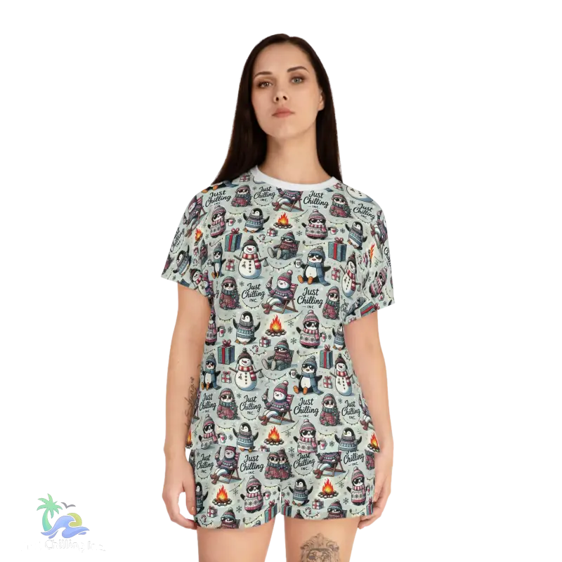 A woman wearing a t-shirt with a repeating pattern of penguins and snowmen.