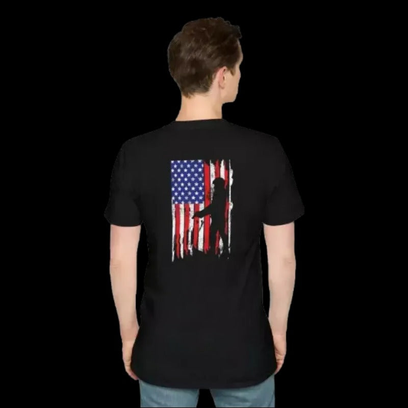 the back of a person wearing a black t-shirt with an American flag design and a silhouette of a person.