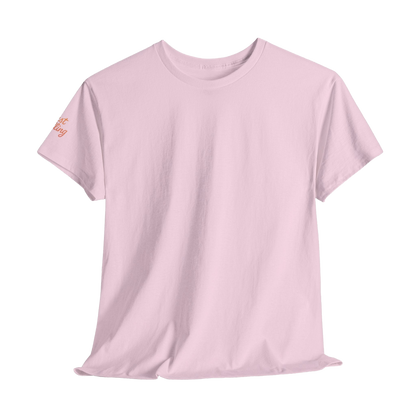 A plain, light pink t-shirt is shown against a black background.