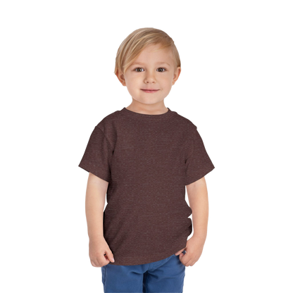 A young boy with blonde hair is smiling and standing against a black background.
