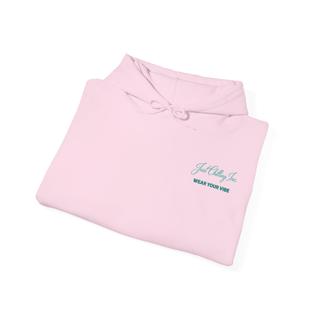 A folded light pink hoodie with a small teal embroidered logo on the left chest reading 'Just Chilling Co.' and 'WEAR YOUR VIBE' underneath, shown on a clean white background.