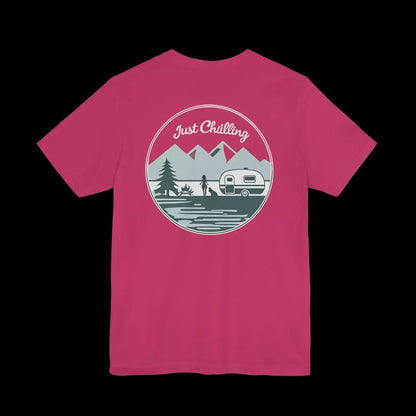 A pink t-shirt with a graphic design featuring a mountain landscape, a camper van, and the text "Just Challenging" in the center.