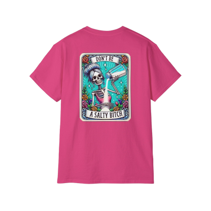 A pink t-shirt with a graphic design featuring a skeleton holding a bottle and the text "DON'T BE A SALTY BITCH" against a colorful background.