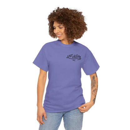 A smiling woman with curly hair wearing a purple t-shirt with the text "Just Chilling Inc." printed on it.
