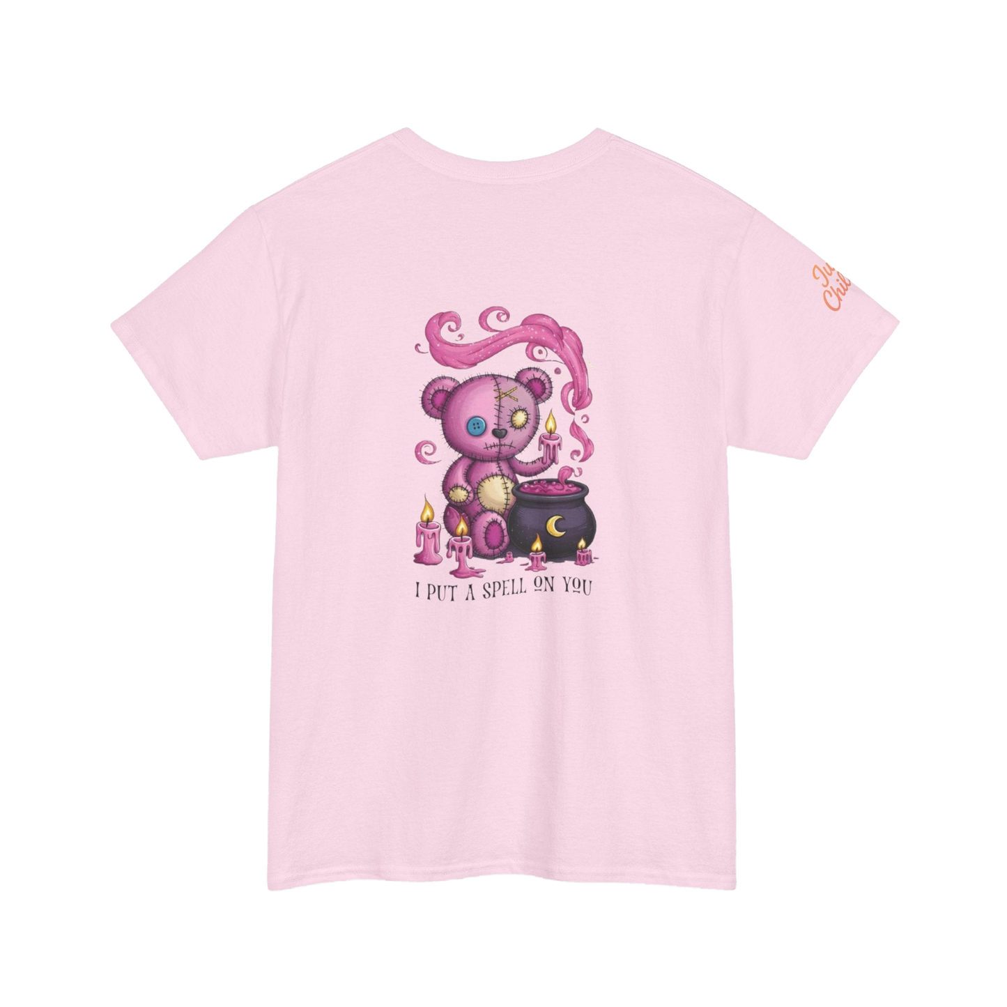 A pink t-shirt with a cartoon image of a teddy bear performing a spell on a cauldron, accompanied by the text "I put a spell on you".