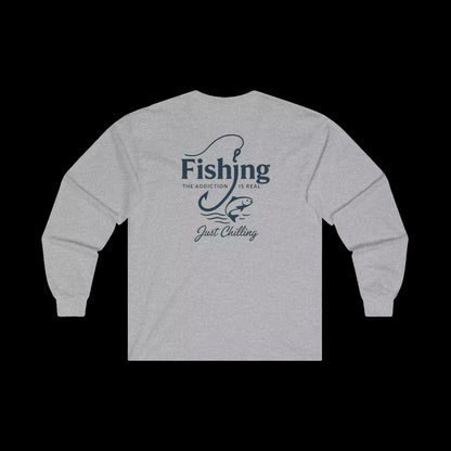 A grey long-sleeved shirt with a graphic design on the back, featuring the text "Fishing is the addiction. Just chilling."