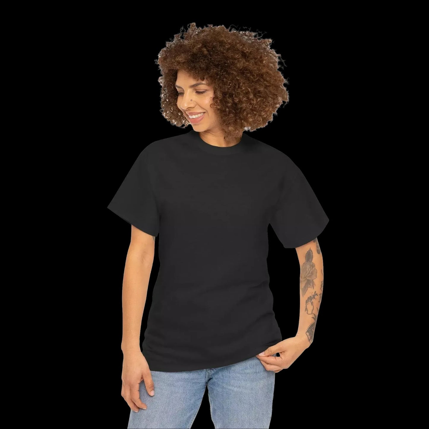 A woman with curly hair is smiling and looking down at her hand.