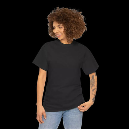 A woman with curly hair is smiling and looking down at her hand.