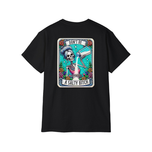 A black t-shirt with a graphic design featuring a skeleton wearing a sombrero and holding a bottle of alcohol, surrounded by colorful flowers and text.