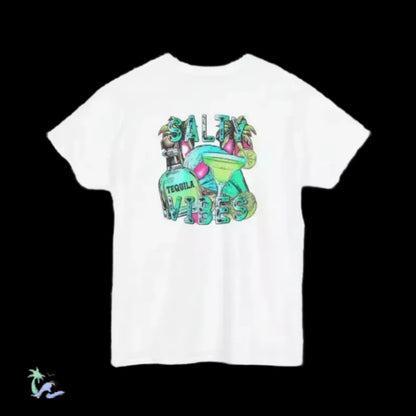 A white t-shirt with a graphic design featuring a tequila bottle, a margarita glass, and the text "SALTY VIBES" in a colorful, stylized font.