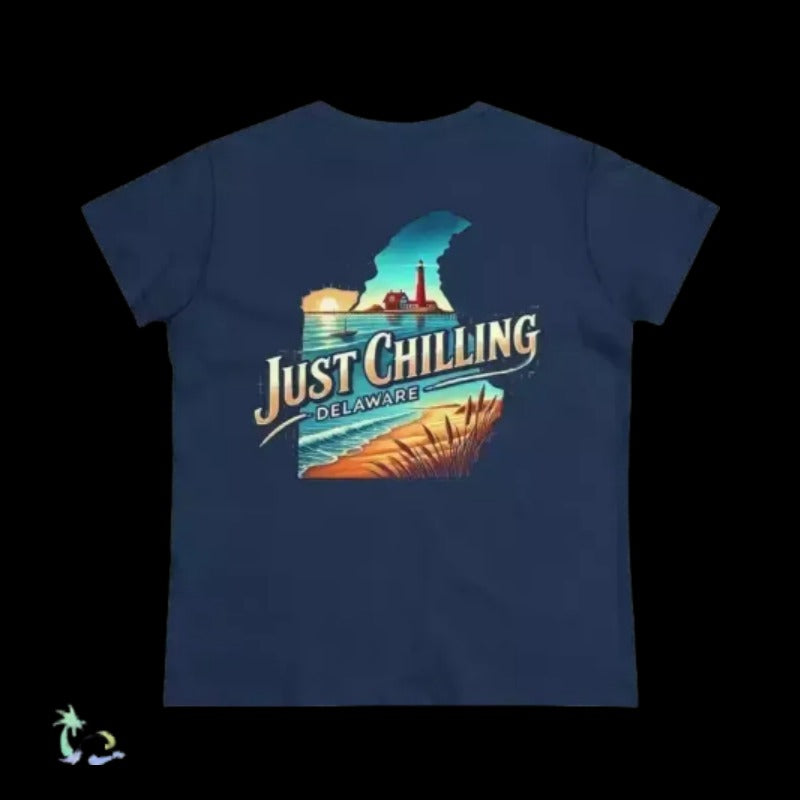 A navy blue t-shirt with a graphic design depicting a beach scene with a lighthouse and a sunset. The text on the t-shirt says "Just Chilling Delaware".