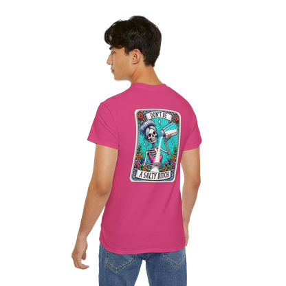 A person wearing a pink t-shirt with a graphic design on the back.