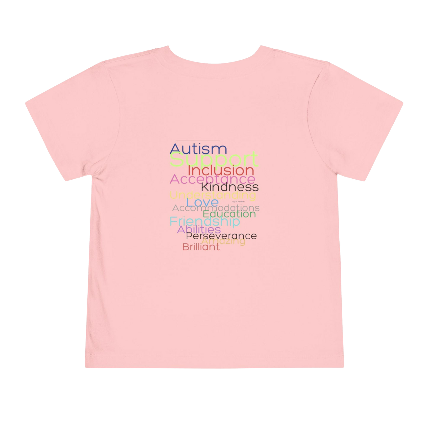 A pink t-shirt with a list of positive traits or characteristics printed on it, including Autism, Inclusion, Kindness, Love, Accompaniments, Education, Perseverance, Brilliance, and others.