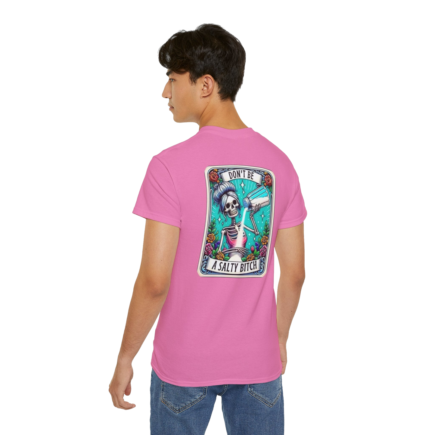 A person wearing a pink t-shirt with a graphic design on the back.