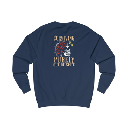 A navy blue sweatshirt with a graphic design on the back, featuring a skull with a rose and the text "Surviving Purely Out of Spite".