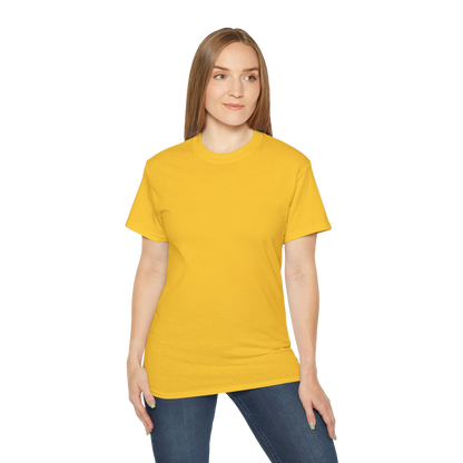A woman wearing a yellow t-shirt and blue jeans stands against a black background.