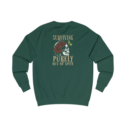 A green sweatshirt with a graphic design on the back, featuring a skull with a rose and the text "Surviving Purely Out of Spite".