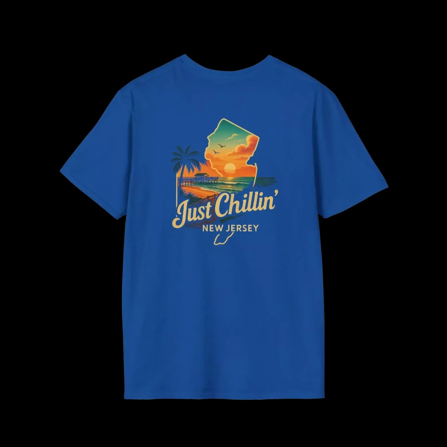 A blue t-shirt with a graphic design depicting a sunset over a beach and palm trees, along with the text "Just Chillin' NEW JERSEY".