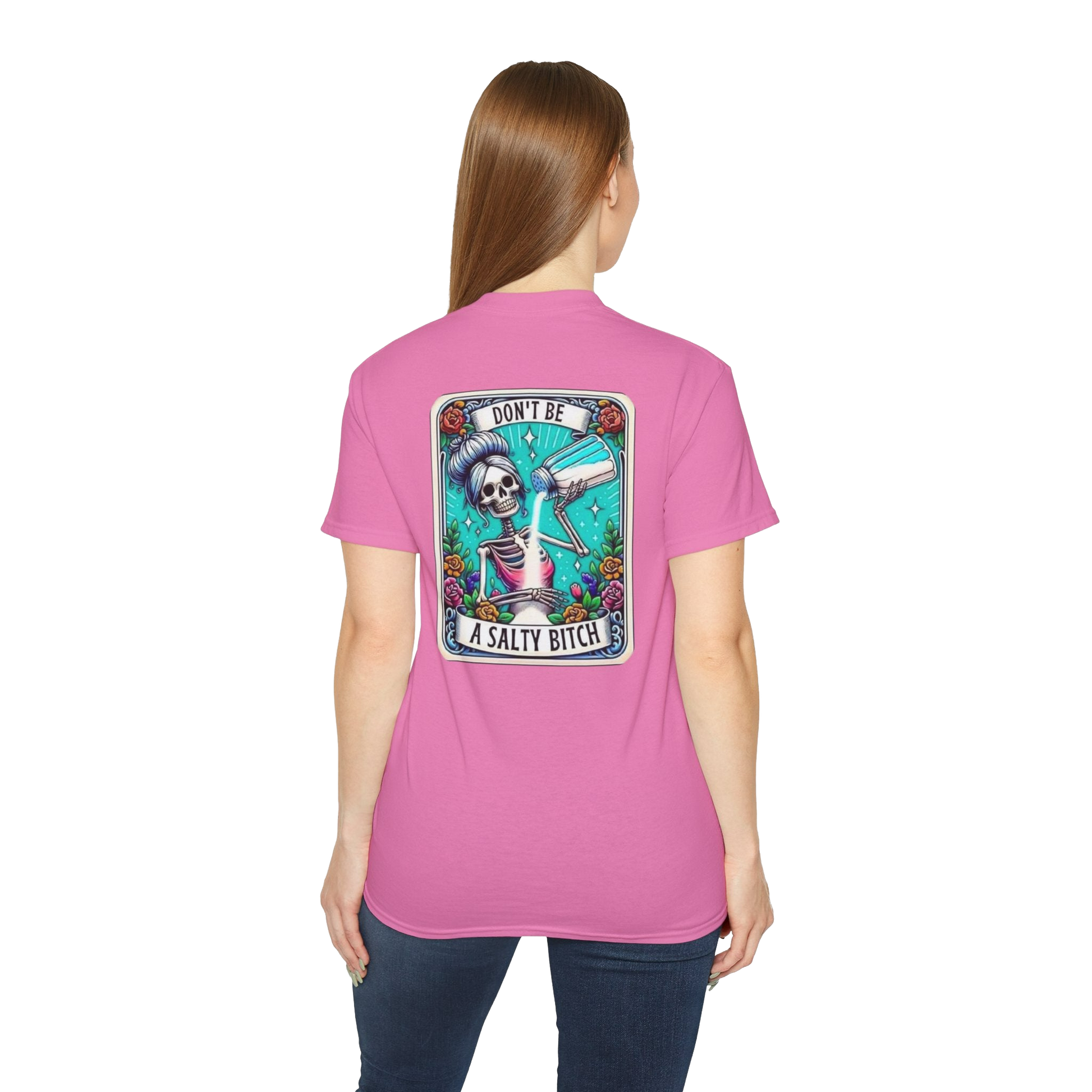 A woman wearing a pink t-shirt with a graphic design on the back.