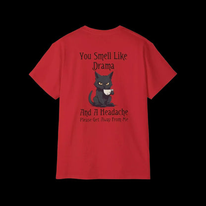 A red t-shirt with a cartoon cat and text that reads "You Smell Like Drama And A Headache Please Get Away From Me".