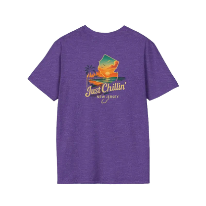 A purple t-shirt with a graphic design featuring a palm tree, a sunset, and the text "Just Chillin' NEW JERSEY" printed on it.