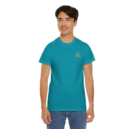 A young man wearing a teal blue t-shirt with a logo on the left side of his chest.