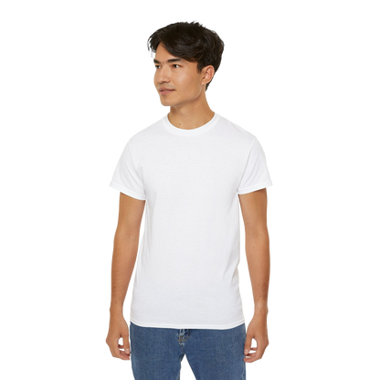 A young man wearing a white t-shirt and blue jeans stands against a black background.