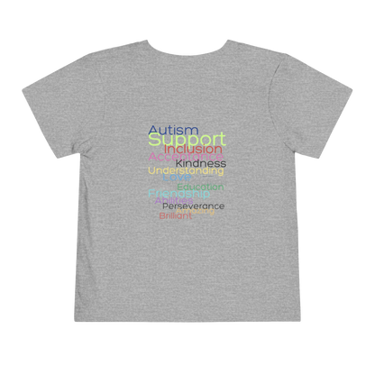 A gray t-shirt with a colorful graphic design featuring the words "Autism Support Inclusion Kindness Understanding Education Perseverance Brilliance" arranged in a visually appealing manner.
