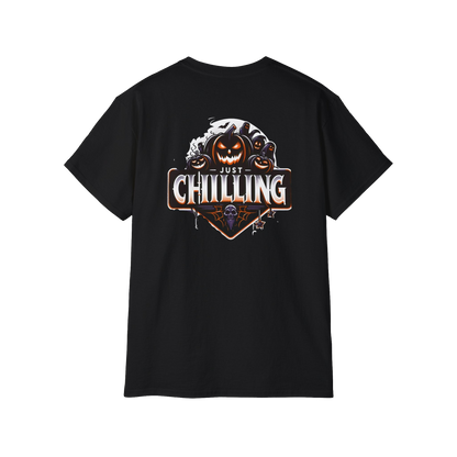 A black t-shirt with a graphic design featuring a pumpkin and a skull, along with the text "Just Chilling" in a stylized font.